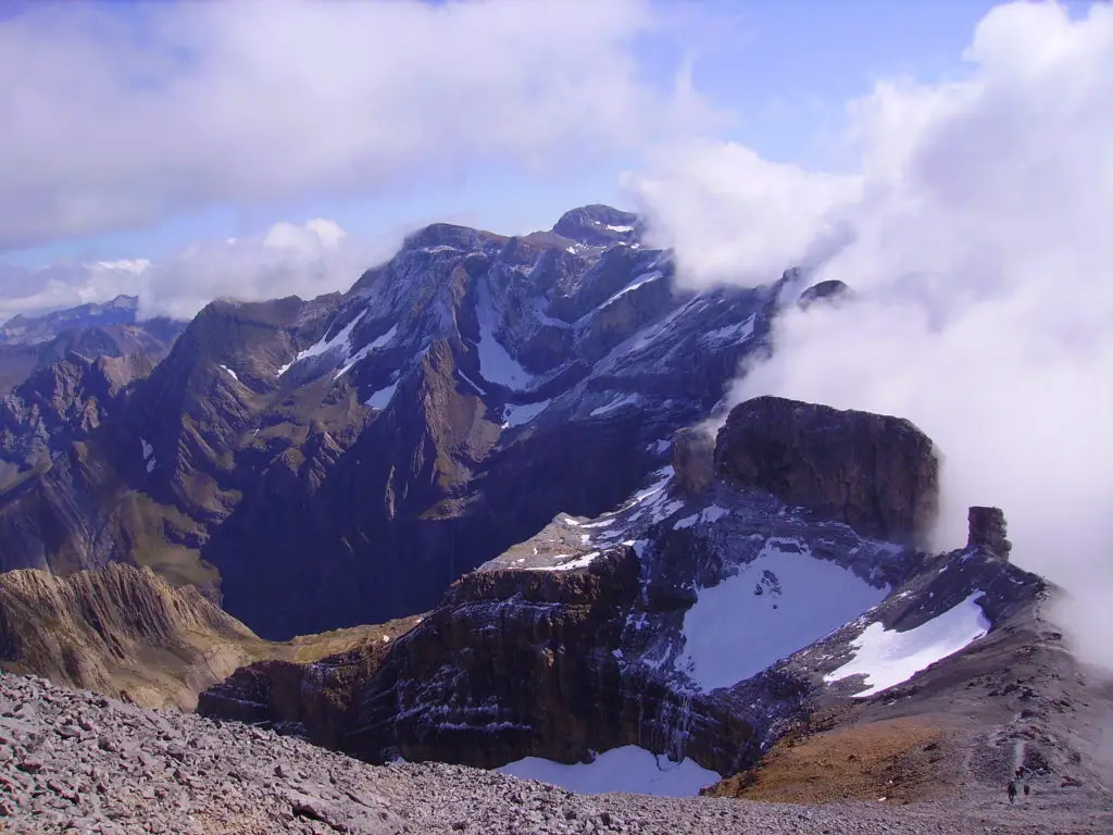 Vue depuis le Taillon sur le Pic du Marboré, nuages bloqués par la crête rocheuse et enneigée, cirque de Gavarnie dégagé, ambiance minérale